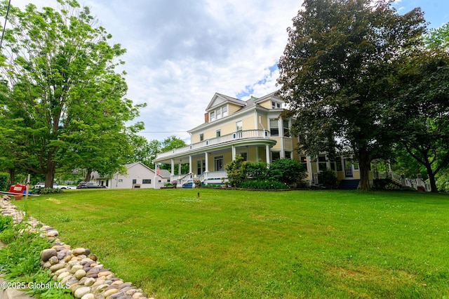 view of green lawn with covered porch