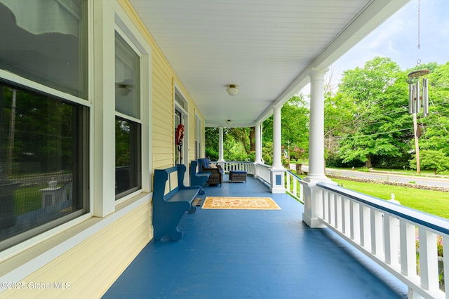 view of patio featuring covered porch and radiator heating unit