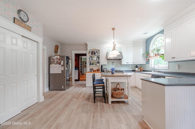 kitchen with stainless steel fridge with ice dispenser, open shelves, wallpapered walls, white cabinetry, and light wood finished floors
