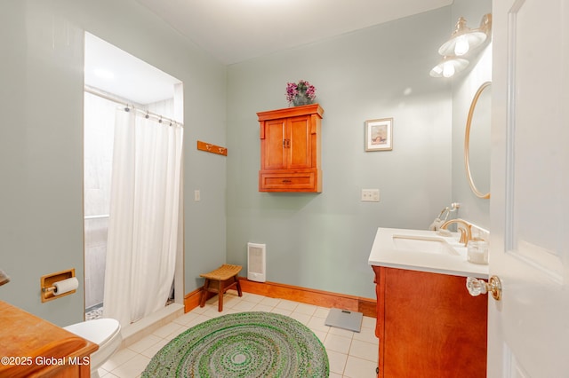 full bath with vanity, a stall shower, tile patterned flooring, and baseboards