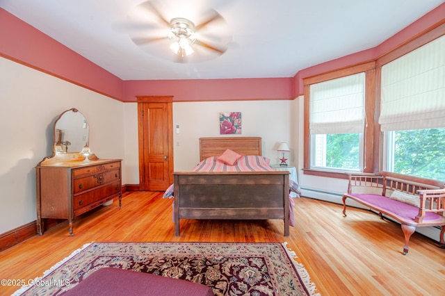 bedroom featuring light wood-type flooring, baseboards, and ceiling fan