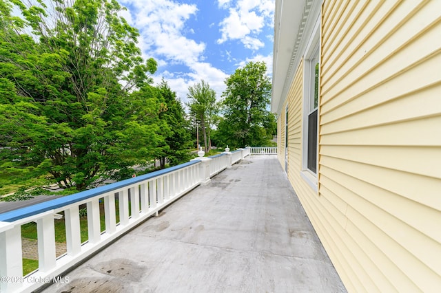 balcony featuring view of wooded area
