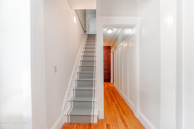 stairway featuring wood finished floors and baseboards