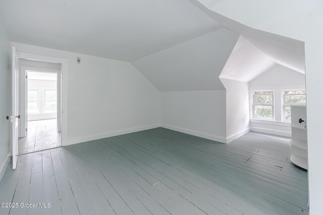bonus room featuring baseboards, wood-type flooring, and lofted ceiling