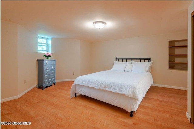 bedroom with light wood-style floors and baseboards