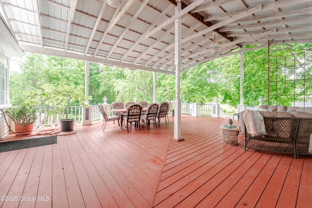 wooden terrace with outdoor dining area and outdoor lounge area