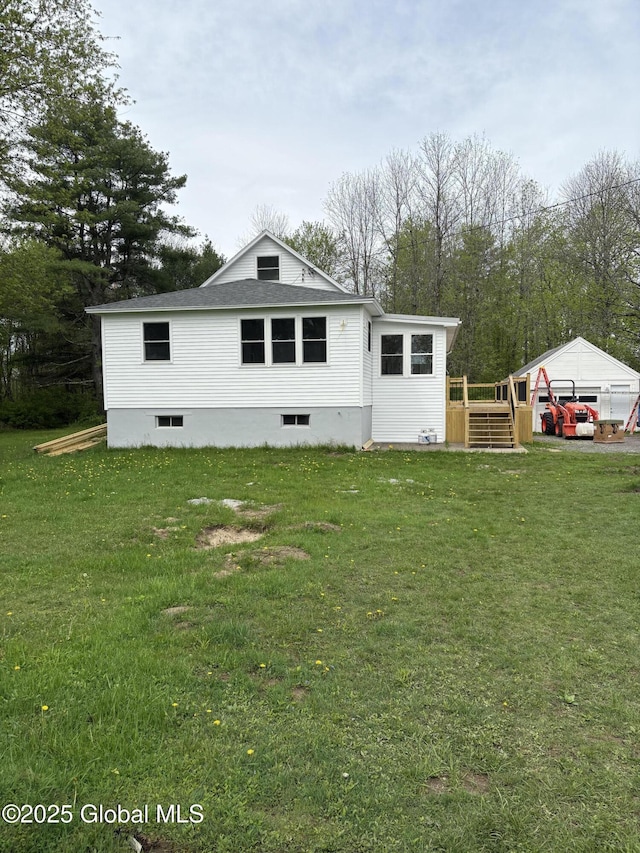 4632 State Highway 30, Broadalbin, NY 12010 - back of property with a detached garage, a lawn, a wooden deck, and roof with shingles