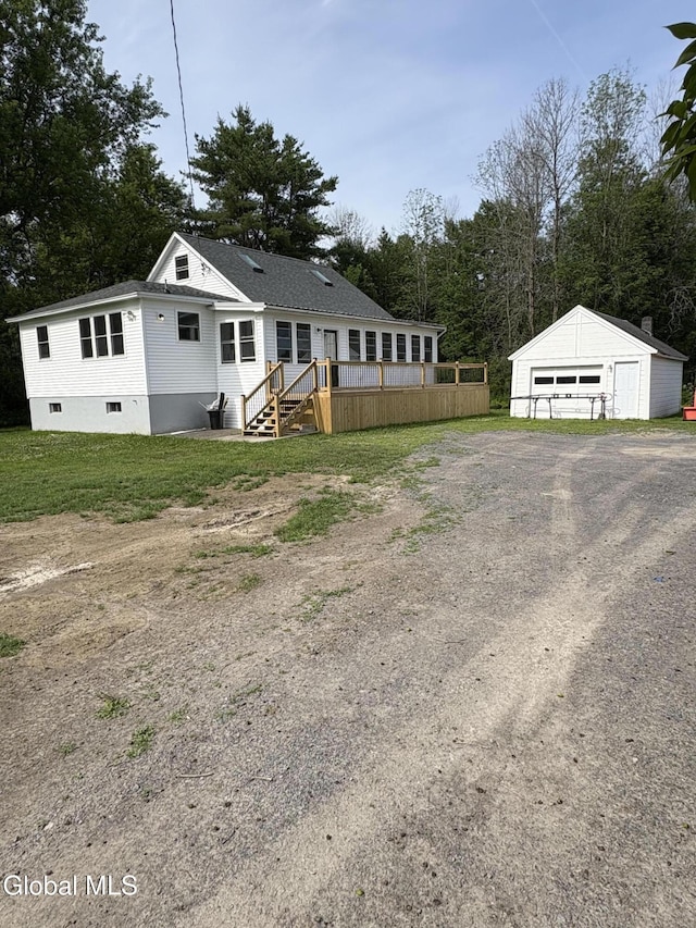 4632 State Highway 30, Broadalbin, NY 12010 - back of property with a garage, an outbuilding, a deck, and view of wooded area