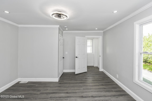 empty room with recessed lighting, baseboards, plenty of natural light, crown molding, and dark wood-type flooring