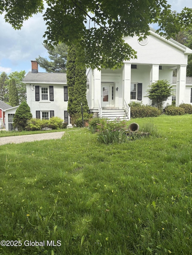 353 Truax Rd, Amsterdam, NY 12010 - view of front of home featuring a chimney and a front lawn