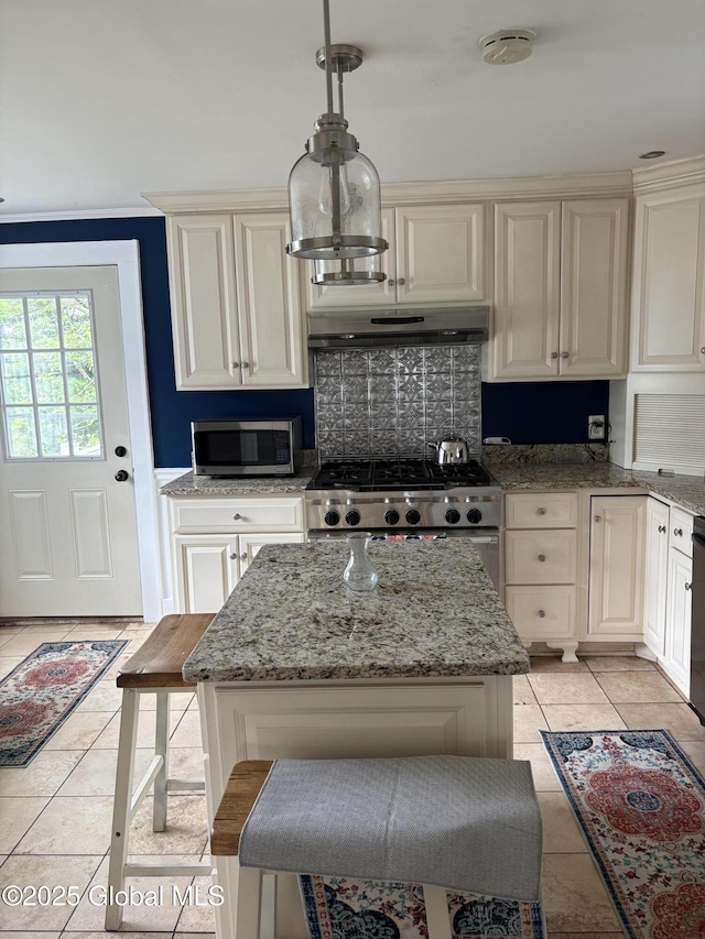 353 Truax Rd, Amsterdam, NY 12010 - kitchen featuring under cabinet range hood, stainless steel appliances, light tile patterned flooring, and tasteful backsplash