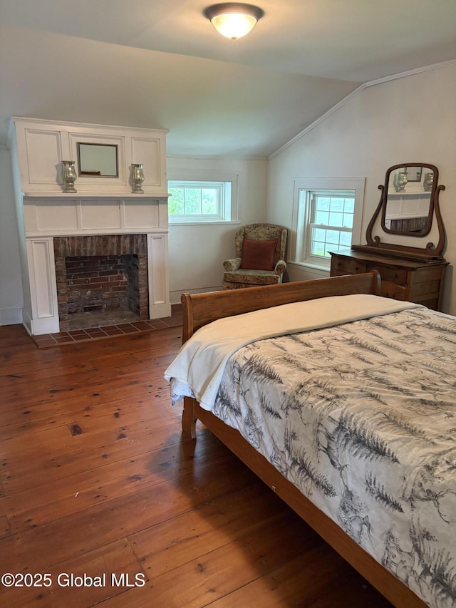 353 Truax Rd, Amsterdam, NY 12010 - bedroom featuring vaulted ceiling, dark wood-style floors, and a fireplace with flush hearth