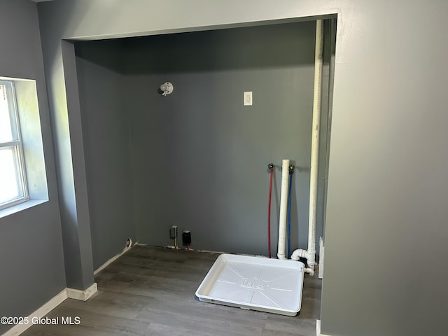 washroom featuring wood finished floors and baseboards