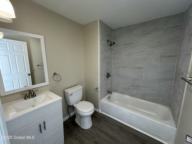 full bathroom with wood finished floors, toilet, vanity, shower / tub combination, and baseboards
