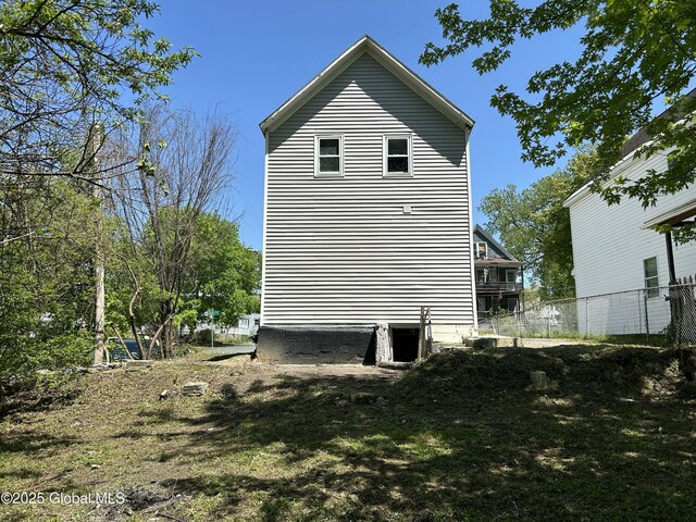 view of home's exterior with central AC and fence