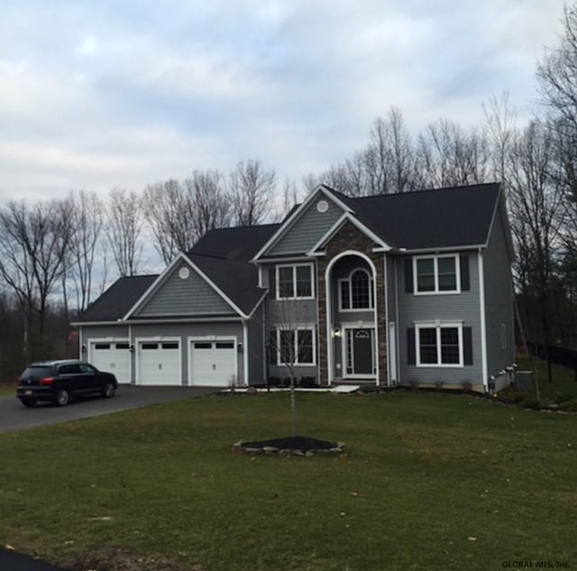 35 Sally St, Halfmoon, NY 12118 - view of front of house featuring asphalt driveway, a front yard, and a garage
