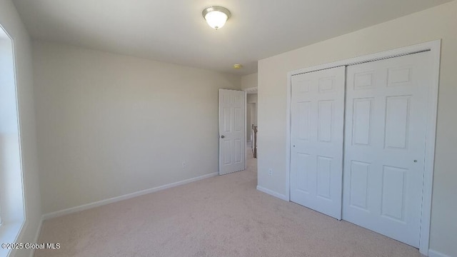 35 Sally St, Halfmoon, NY 12118 - unfurnished bedroom with light colored carpet, a closet, and baseboards