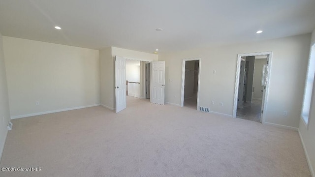 35 Sally St, Halfmoon, NY 12118 - unfurnished bedroom with a spacious closet, recessed lighting, light colored carpet, ensuite bath, and baseboards