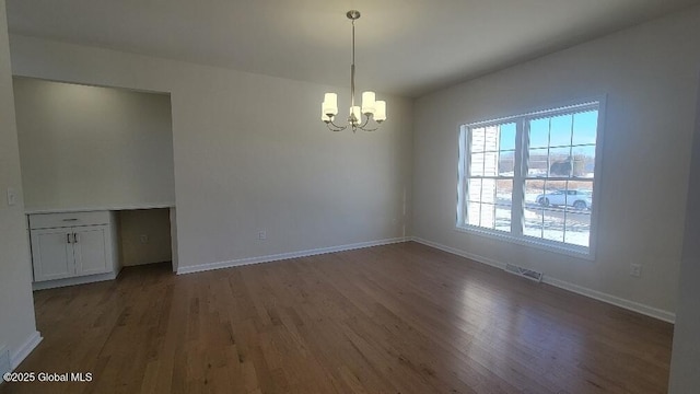 35 Sally St, Halfmoon, NY 12118 - unfurnished dining area with a chandelier, wood finished floors, and baseboards