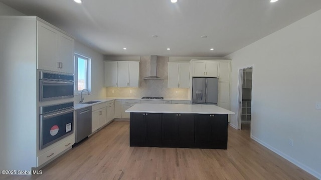 35 Sally St, Halfmoon, NY 12118 - kitchen featuring appliances with stainless steel finishes, a sink, wall chimney range hood, a center island, and decorative backsplash