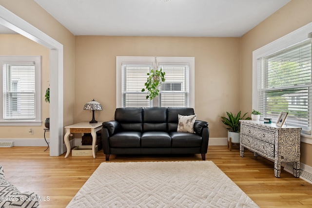 living area featuring light wood-style flooring and baseboards