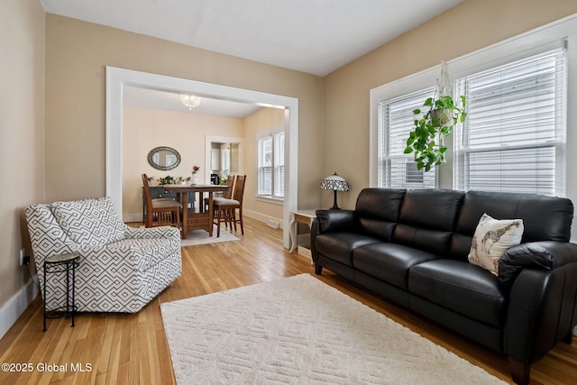 living room with light wood finished floors and baseboards