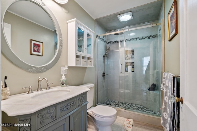 full bathroom with toilet, a shower stall, vanity, and wood finished floors