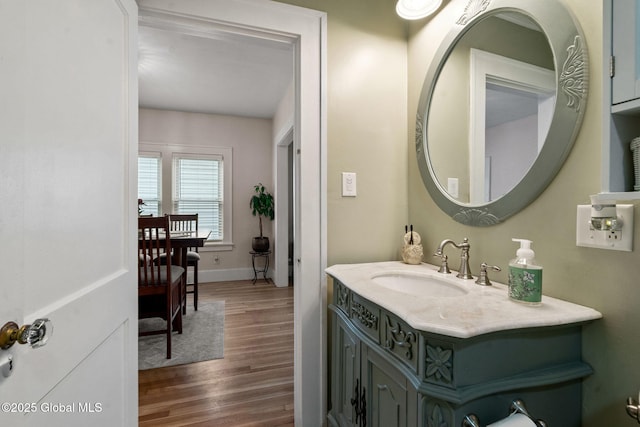 bathroom featuring wood finished floors, vanity, and baseboards