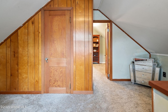 additional living space featuring carpet flooring, vaulted ceiling, and baseboards