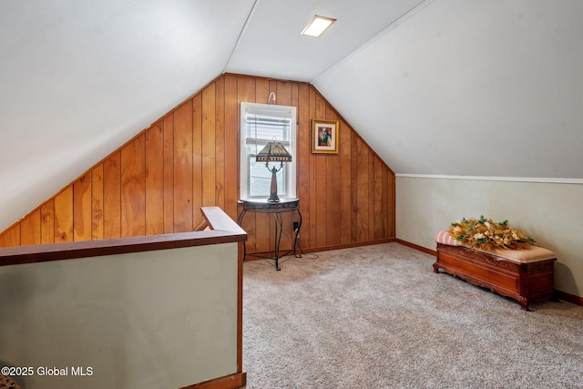 bonus room featuring lofted ceiling, wooden walls, carpet, and baseboards