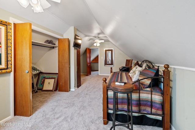 carpeted bedroom with lofted ceiling and a ceiling fan