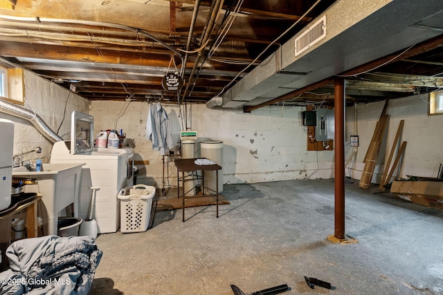 basement featuring independent washer and dryer and electric panel