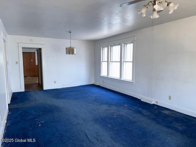 spare room with baseboards and a ceiling fan