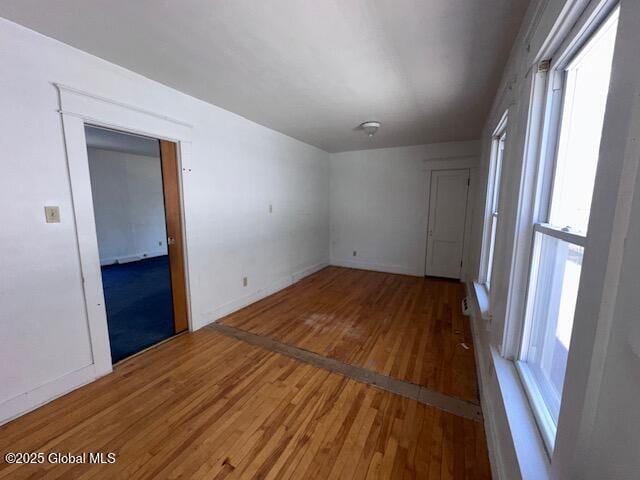 spare room with wood finished floors and baseboards