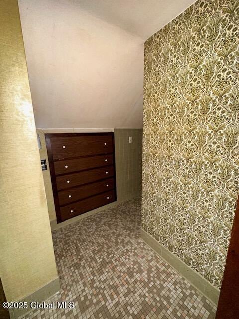 bonus room featuring wallpapered walls, baseboards, and vaulted ceiling