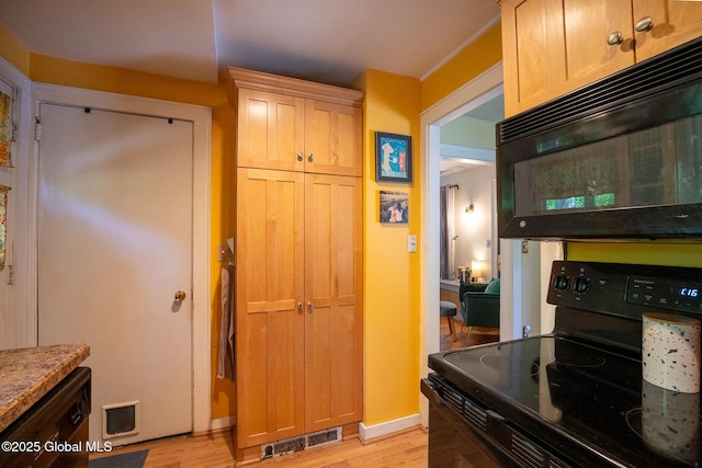 8 Pineridge Pl, Bethlehem, NY 12054 - kitchen with black appliances, light wood finished floors, and baseboards