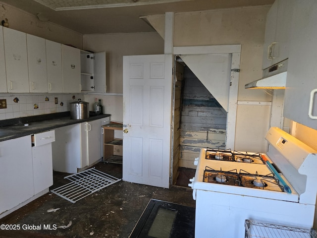 89 Forbes St, Amsterdam, NY 12010 - kitchen featuring white gas range oven, white cabinetry, under cabinet range hood, concrete floors, and dark countertops