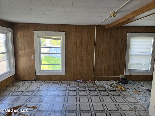 89 Forbes St, Amsterdam, NY 12010 - spare room featuring wood walls, healthy amount of natural light, and tile patterned floors