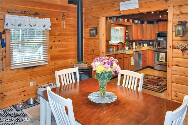 152 Sweenie Fields Rd, Schroon Lake, NY 12870 - dining space with wood walls and a wood stove