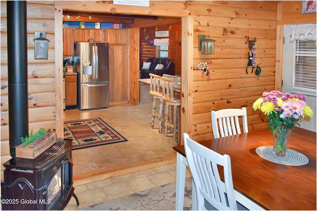 152 Sweenie Fields Rd, Schroon Lake, NY 12870 - dining room with a wood stove and rustic walls