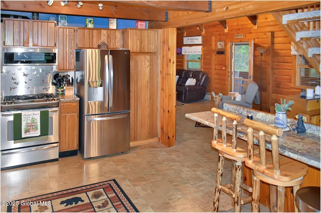 152 Sweenie Fields Rd, Schroon Lake, NY 12870 - kitchen featuring appliances with stainless steel finishes, wooden walls, and brown cabinets