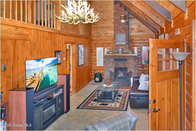 152 Sweenie Fields Rd, Schroon Lake, NY 12870 - living room featuring high vaulted ceiling, a chandelier, wood walls, a fireplace, and beam ceiling