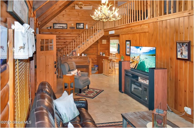 152 Sweenie Fields Rd, Schroon Lake, NY 12870 - living room with a chandelier, wood walls, high vaulted ceiling, and stairway