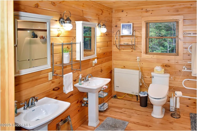 152 Sweenie Fields Rd, Schroon Lake, NY 12870 - bathroom with a sink, toilet, wood finished floors, and wooden walls