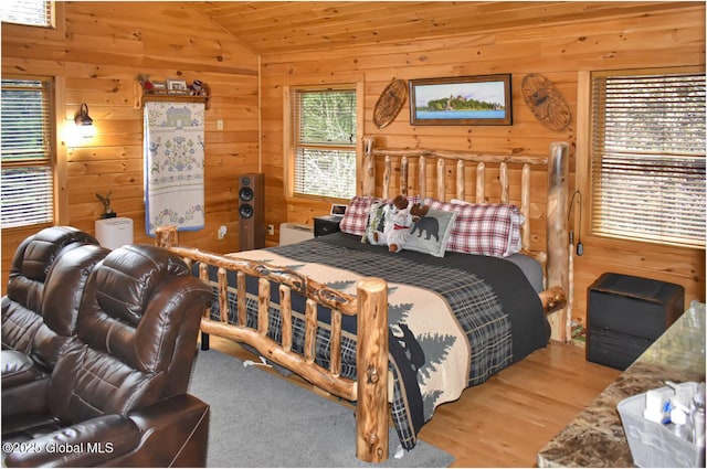 152 Sweenie Fields Rd, Schroon Lake, NY 12870 - bedroom with vaulted ceiling, wood walls, and wood finished floors