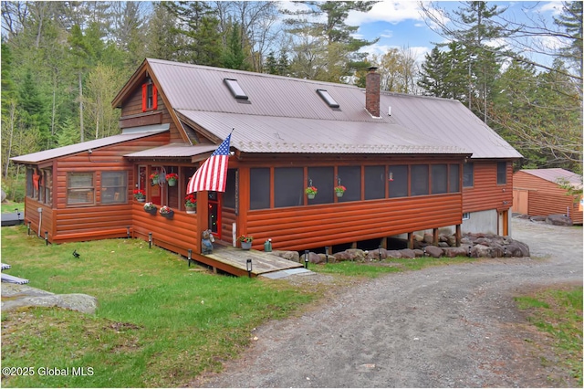 152 Sweenie Fields Rd, Schroon Lake, NY 12870 - view of front of property with a chimney, a sunroom, metal roof, and faux log siding