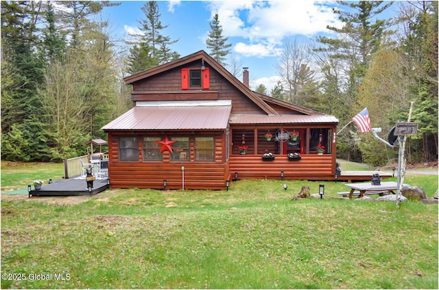 152 Sweenie Fields Rd, Schroon Lake, NY 12870 - view of front facade featuring log veneer siding, a front yard, and a deck