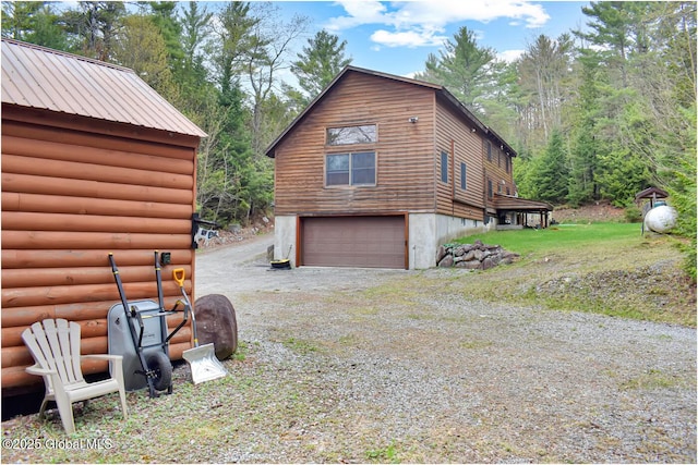 152 Sweenie Fields Rd, Schroon Lake, NY 12870 - view of home's exterior with a garage, driveway, and faux log siding