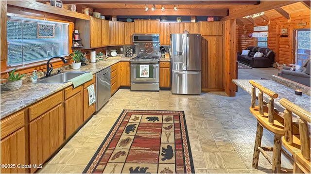 152 Sweenie Fields Rd, Schroon Lake, NY 12870 - kitchen featuring stainless steel appliances, a sink, beam ceiling, track lighting, and open floor plan