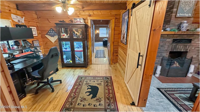 152 Sweenie Fields Rd, Schroon Lake, NY 12870 - office area with a barn door, wooden walls, a ceiling fan, wooden ceiling, and beam ceiling